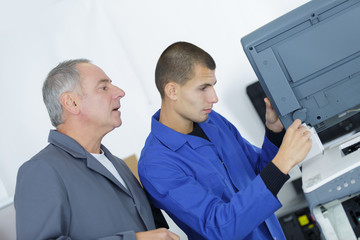 apprentice mending an office scanner