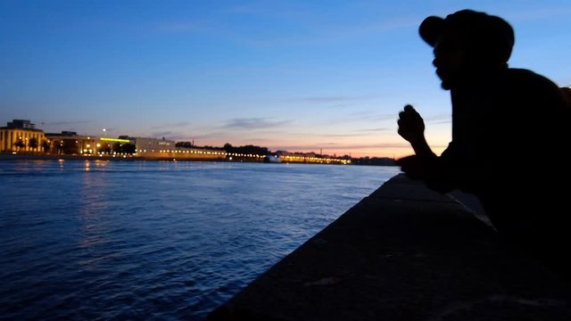 the young man smokes cigarettes. silhouette