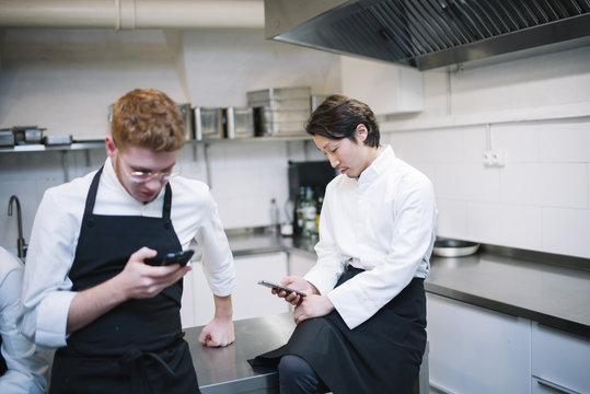 Chef's using a smartphone in kitchen