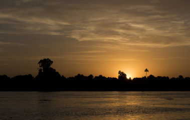 River bank silhouette at dusk sunset