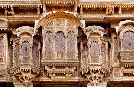 Stone balcony and carved windows of ancient stone fortress, Rajasthani, India