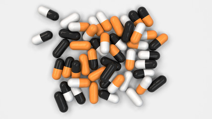 Pile of black, white and orange medicine capsules