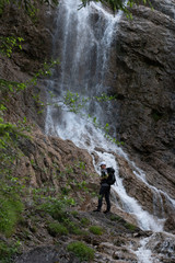 Obraz premium waterfall on the forest with person 