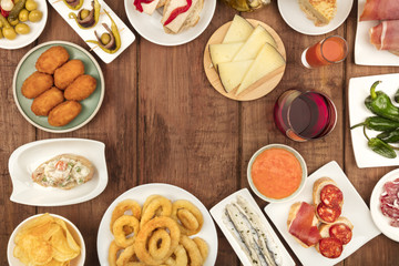 The food of Spain. Overhead photo of many different Spanish tapas with wine and copy space