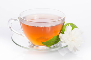 Glass cup of Tea with jasmine flowers and leaves