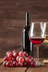 Glass of red wine with grapes and copy space