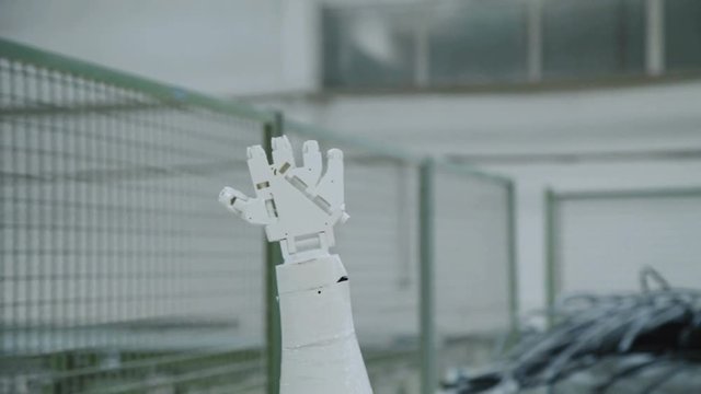 The robotic hand show gestures of opening fingers on the camera. 4K
