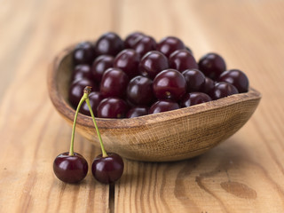 cherries on a wooden table. 