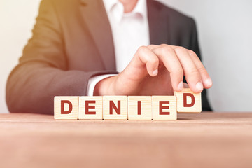 Man made word DENIED with wood blocks