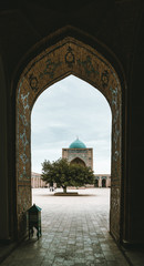 View through portal of Poi Kalon Mosque and Minaret in Bukhara, Uzbekistan