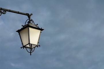 Fototapeta na wymiar Old fashioned street lamp against cloudy sky (with copy space)