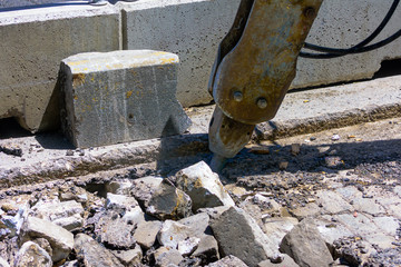A drilling machine performs works on a street