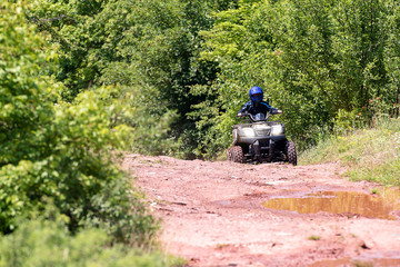 A trip on the ATV on the red road.