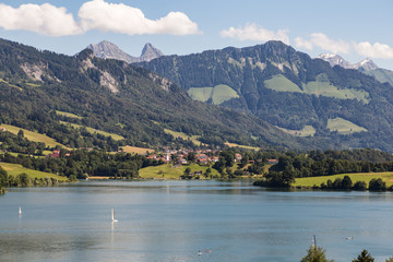 Obraz premium Gruyeres lake with the alps in the background in Canton Fribourg in Switzerland