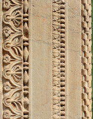 Detail of an ancient medieval portal frieze as background