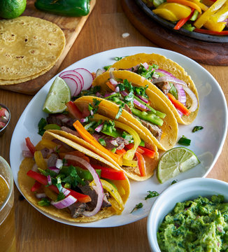 Mexican Fajita Tacos In Yellow Corn Tortilla Served With Guacamole