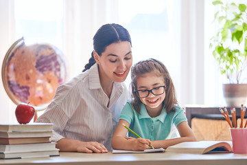 Mother and daughter are learning to write