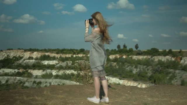 Beautiful young girl taking pictures of nature