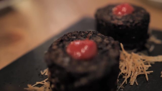 Spanish gastro bar chef blood sausages with rice and red sause
