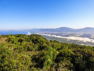 Naklejka na ściany i meble A view of Mocambique beach, sand dunes and urban area from the top of Morro das Aranhas (Florianopolis, Brazil)