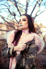 Young stylish woman in winter jacket with fur