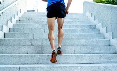Close up of young man running up the stairs with running clothes