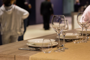 Fototapeta na wymiar Empty wine glasses near the plates on the table