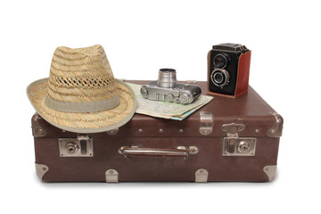 Vintage suitcase and old camera on a white background