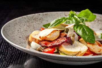Italian Cuisine. Classic Caesar salad with chicken, cherry tomatoes, mix salad, parmesan cheese, bread croutons, rusks and basil. The concept is a beautiful serve in the restaurant. Copy space