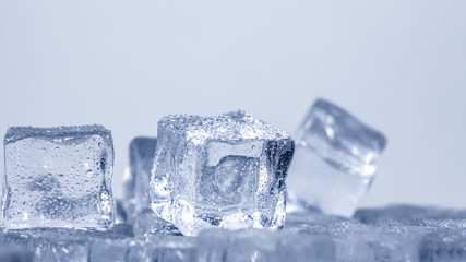 Cubes of ice covered with water drops. Frozen water in form of a cube, ice. Critically pure ice.