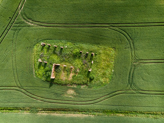 drone image. aerial view of rural area with green cultivated fields and old abandoned building ruins in the middle