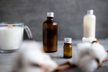 Spa cosmetics in brown glass bottles on gray concrete table. Copy space. Beauty blogger, salon therapy, minimalism concept