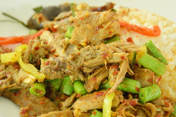 spicy fried duck meat curry with basil leaf and rice on plate