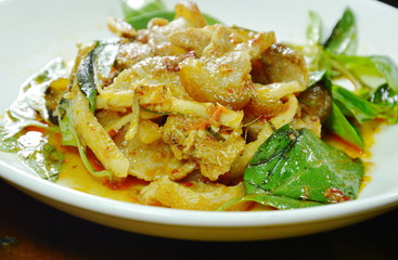 stir fried spicy wild boar and coconut shoot with red curry on plate