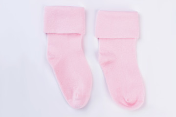 Pink baby wool socks isolated on white.
