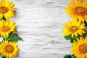 Beautiful sunflowers on a wooden table. View from above. Background with copy space.