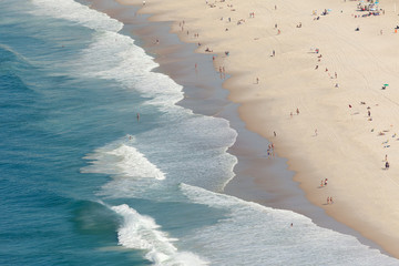 Ocean waves coming in at the Copacabana beach in Rio de Janeiro seen from a high vantage point