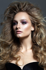Fototapeta premium Beautiful young model with professional makeup, perfect skin, volume hairstyle