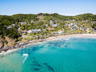 The Pass and Wategoes Beach at Byron Bay from an aerial view with blue water