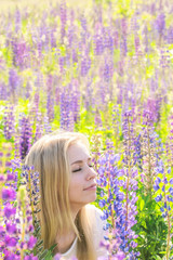 Young woman on the field in flowers
