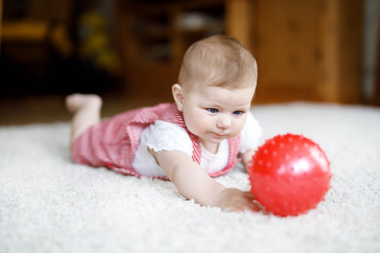 Cute Baby Girl Playing With Red Gum Ball.