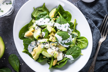 Green salad with avocado, spinach egg and cucumber. 