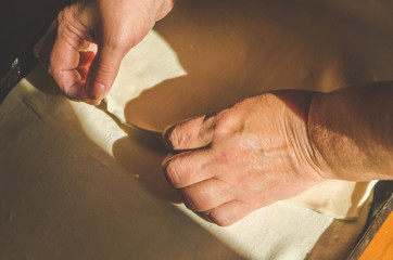 Apple jam next to the baking sheet of rolled dough