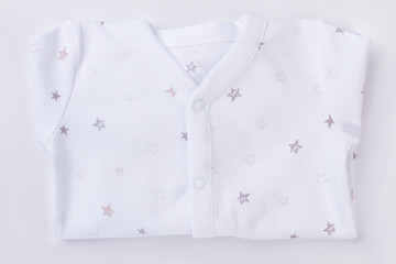 White folded baby pajamas.