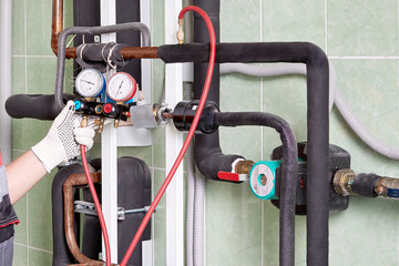 A worker checks the operation of the heating system.