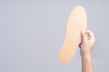 Hand holding replacement shoe sole