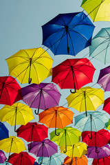 Fototapeta na wymiar Multicolored umbrellas against the sky, street decorated