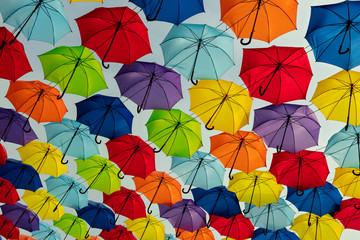 Fototapeta na wymiar Multicolored umbrellas against the sky, street decorated