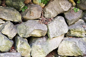 Wall of old stone boulders. Ancient structure of stones.