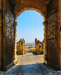 wooden open gate with view over city in medieval castle on the hill in little town Melfi, Basilicata Italy                      - obrazy, fototapety, plakaty